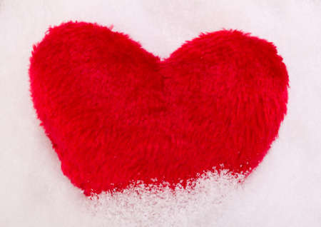 Red heart in snowの写真素材