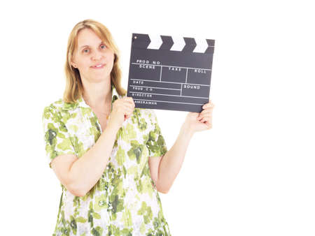 Beautiful woman with clapperboard having fun on locationの写真素材