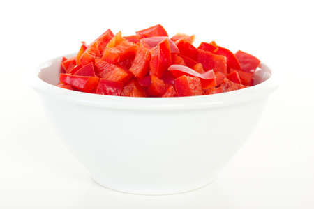 Cutted red peppers in white bowlの写真素材