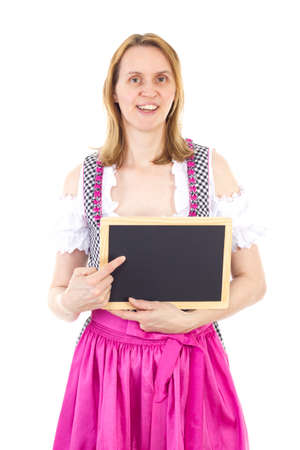 Bavarian woman pointing to clean blackboardの写真素材