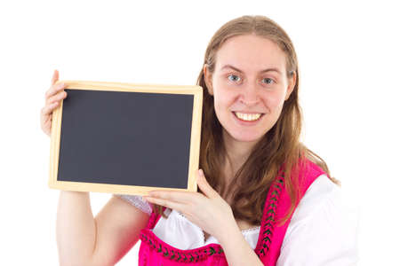 Beautiful woman in dirndl showing blank blackboardの写真素材