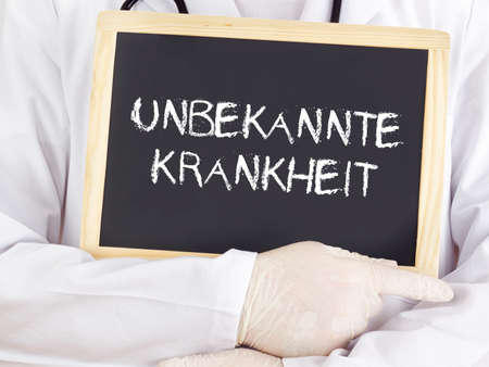 Doctor shows information: Unknown disease in germanの写真素材