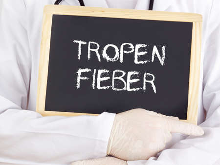 Doctor shows information: Tropical fever in germanの写真素材