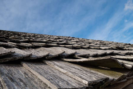 ancient wooden tiles on the roof of the hutの写真素材