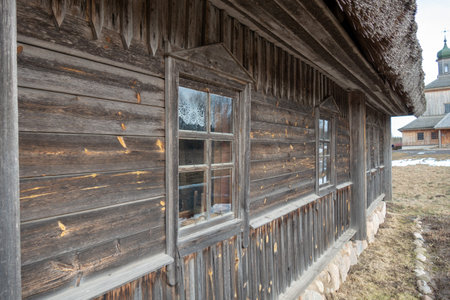 old wooden farmhouse with a thatched roofの写真素材