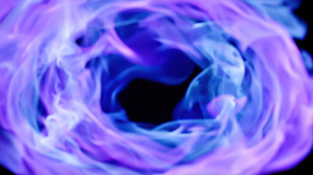 Abstract swirling smoke in vibrant purple and blue tones creates an ethereal atmosphere. Ideal for backgrounds, artistic projects, or visual effects.の素材