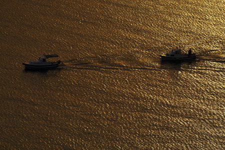 two boats in sunsetの写真素材