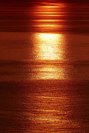 Sunset reflection in sea taken from cliffの写真素材