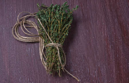 Bunch of fresh thyme on old wooden backgroundの写真素材