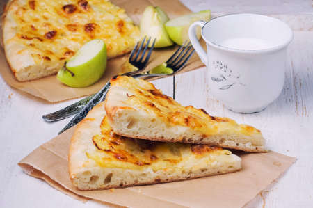 Open pie with apples and cheese on a light backgroundの写真素材