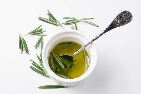 olive oil with rosemary on a light backgroundの写真素材