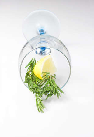Rosemary and lemon in a glass on a light backgroundの写真素材