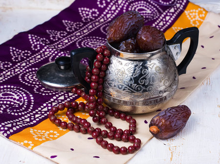 Dates fruit and rosary still life