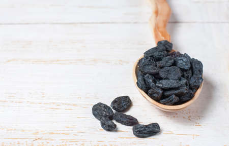 Black raisins on a wooden backgroundの写真素材