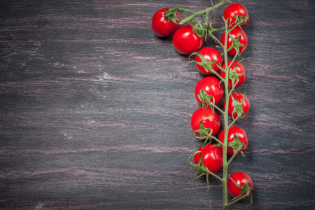 fresh organic cherry tomatoes  on a dark backgroundの写真素材
