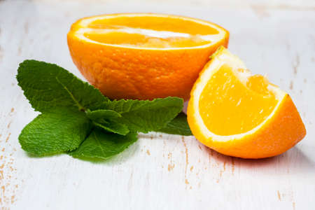 Oranges with fresh mint on a white background wooden, selective Focusの写真素材