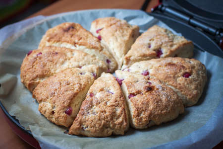 Closeup of freshly baked scones with pomegranate seeds. Selective focus.の写真素材