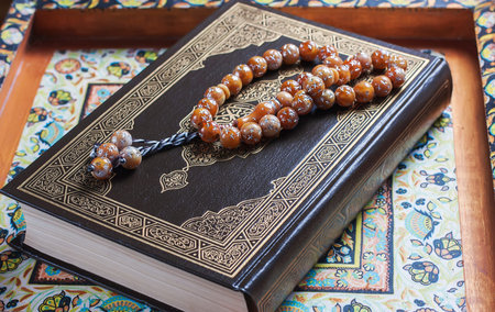 Prayer beads on the Koran. Selective focus