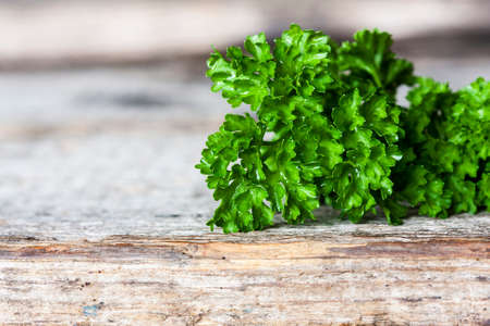 Fresh parsley on wood background. Selective focusの写真素材