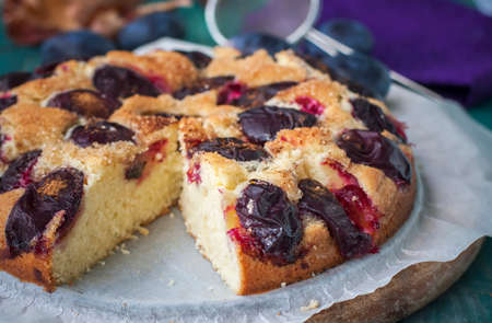 Homemade plum cake with cinnamon on wooden table. selective focusの写真素材