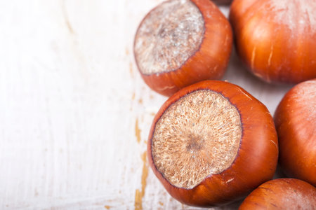 Hazelnuts, filbert on old wooden background, selective focus