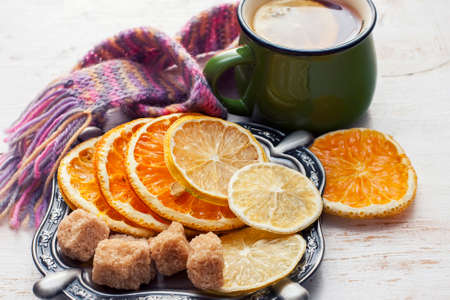 Orange and lemon slices on old wooden table. Winter time. Selective focusの写真素材