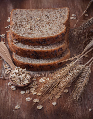Healthy wholegrain bread on burlap napkin,  located on wood background. Selective focus