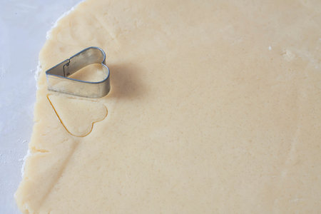 Dough with a heart shape, selective focusの写真素材