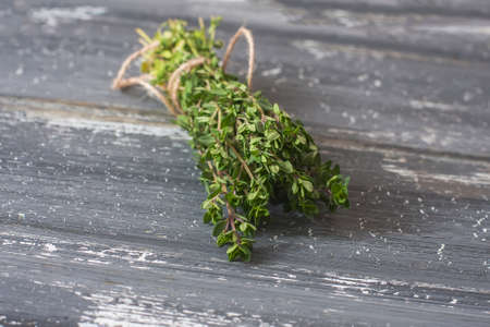 Bunch of fresh organic thyme on a wooden  surface. Selective focusの写真素材