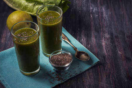 green smoothie with fruits and vegetables on black background. Selelective focusの写真素材