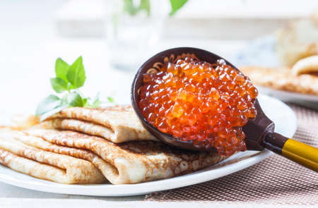 Pancakes with salmon caviar,  traditional Russian meal. Selective focusの写真素材