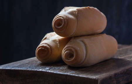 Homemade bread rolls on a dark wooden background. Selective focusの写真素材