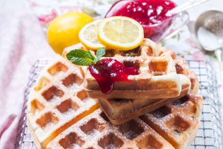 Homemade Belgian waffles with lemon and sugar powder. Selective focusの写真素材