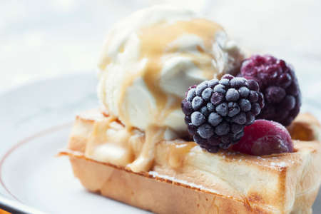Belgian waffles with caramel and ice cream. Selective focusの写真素材