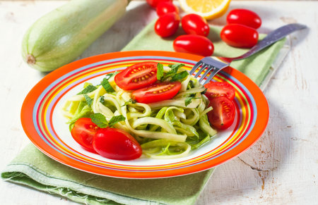 vegetarian zucchini noodles with cherry tomatoes and mint. Selective focusの写真素材