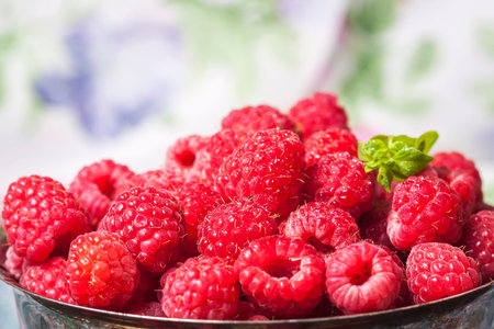 Fresh  raspberries in vintage basket, vitamins, healthy food, vegan ingredients. Selective focus