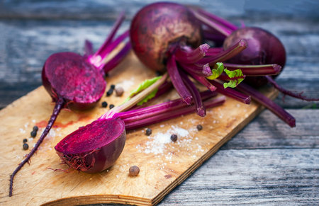 Fresh, organic raw beetroot against a wooden background. Selective focus