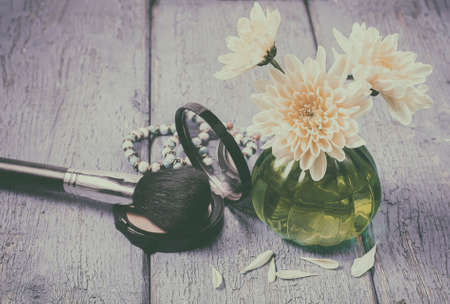 yellow flower chrysanthemum, women's accessories on blue wooden background. Selective focus and toned imageの写真素材
