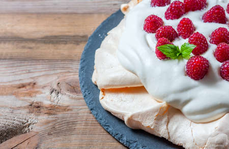 Homemade cake "Pavlova" with whipped cream and fresh raspberry. Selective focusの写真素材