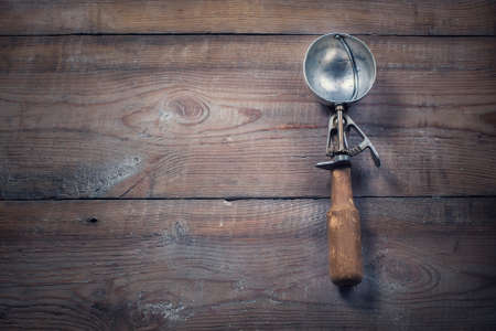 Vintage Ice Cream Scoop, on rustic wooden background.の写真素材
