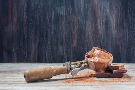 Scoop of chocolate ice cream on rustic wooden background. Selective focusの写真素材