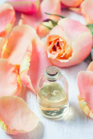 Bottle with essential aroma oil on white wooden background. Selective focus. Place for text.の写真素材
