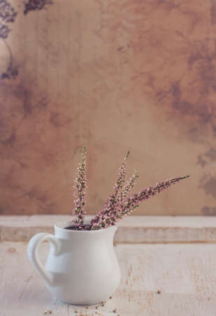 Heather in a white vase. Selective focusの写真素材
