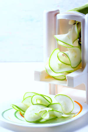 Making zucchini noodles using spiralizer. Selective focus.の写真素材