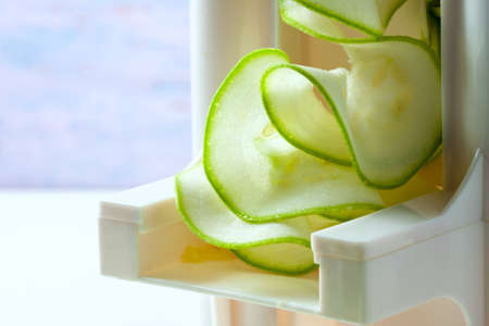 Making zucchini noodles using spiralizer. Selective focus.の写真素材