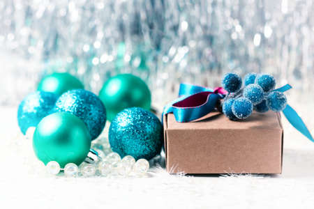 Christmas gift box with ribbon and christmas decoration on a white background, soft focusの写真素材