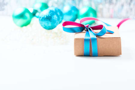 Christmas gift box with ribbon and christmas decoration on a white background, soft focusの写真素材