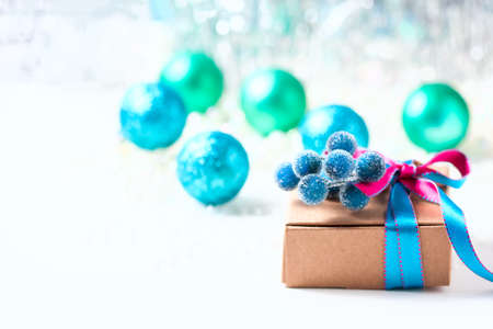 Christmas gift box with ribbon and christmas decoration on a white background, soft focusの写真素材
