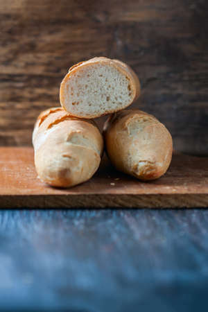 Fresh baguette on wooden table, close up. Selective focusの写真素材