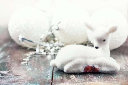Small white deer and christmas decorations white background. copy space, soft focusの写真素材